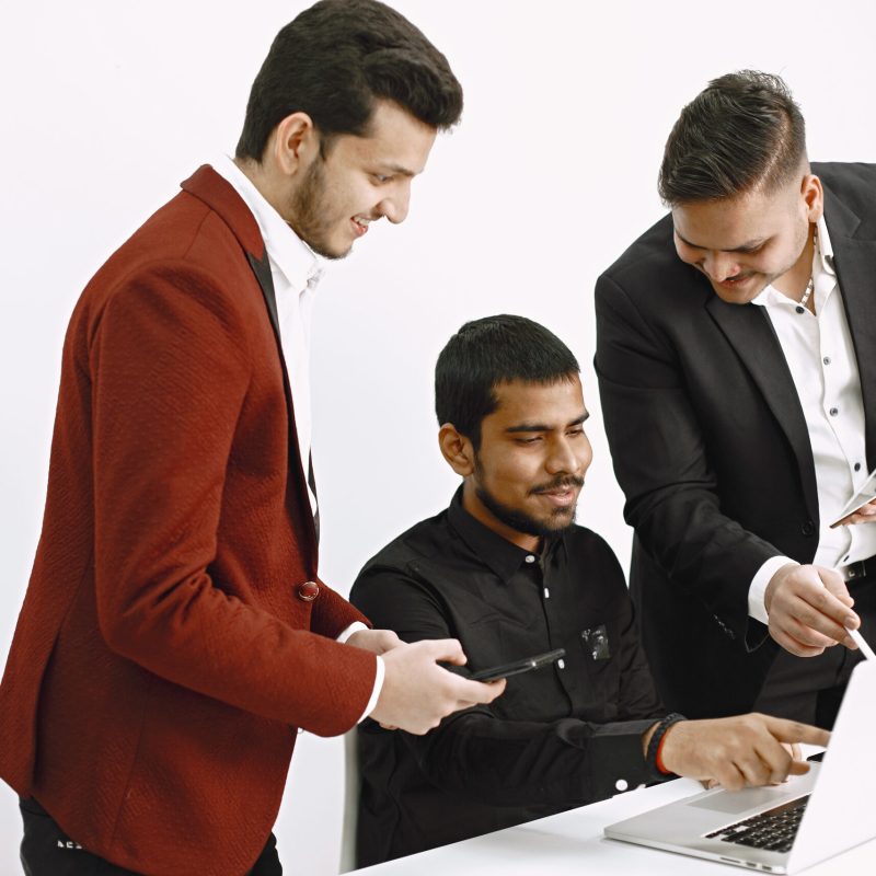 Isolated. Three neb discussing ideas. White background. Indian nationality.